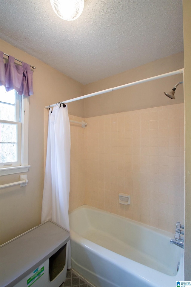 bathroom featuring shower / tub combo and a textured ceiling