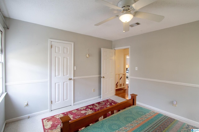 bedroom with ceiling fan and a closet