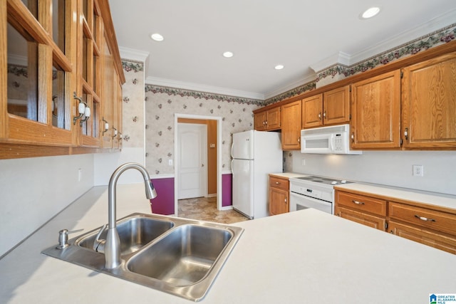 kitchen with crown molding, white appliances, and sink