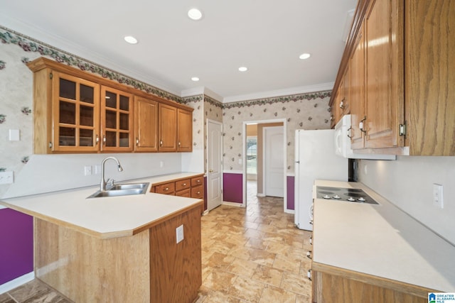 kitchen featuring kitchen peninsula, white refrigerator, crown molding, and sink