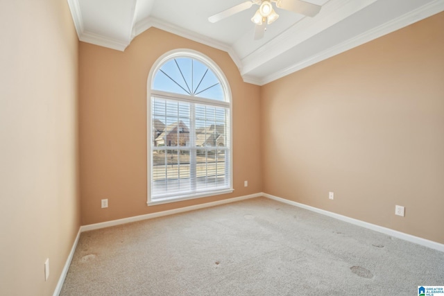 carpeted empty room featuring vaulted ceiling, ceiling fan, and crown molding