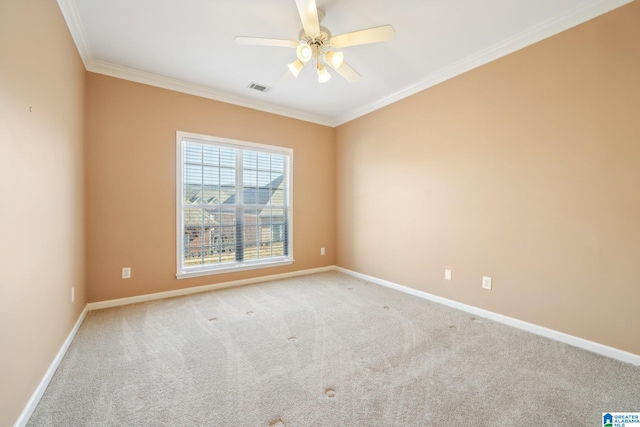 carpeted empty room with ceiling fan and ornamental molding