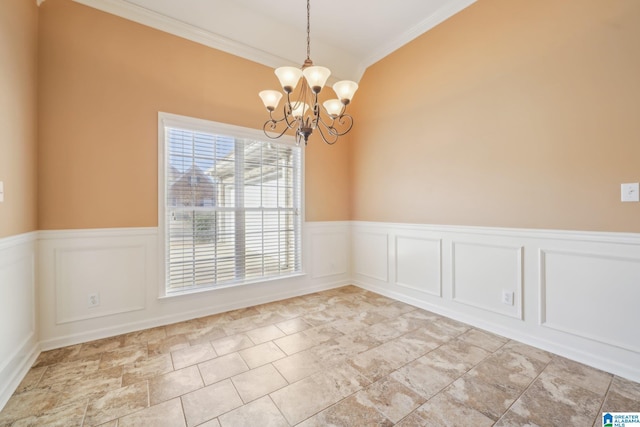 spare room featuring vaulted ceiling, ornamental molding, and a chandelier