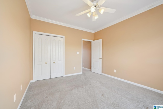 unfurnished bedroom featuring a closet, light colored carpet, ceiling fan, and ornamental molding