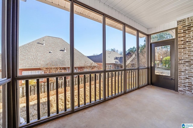 unfurnished sunroom with wood ceiling