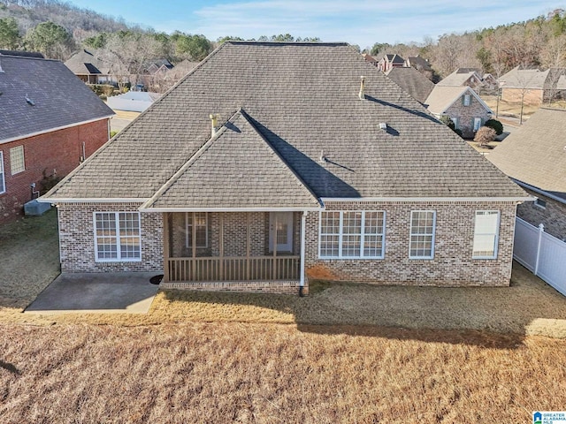 rear view of house with a yard and a patio