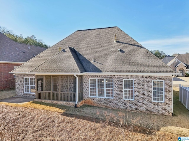 rear view of house featuring a sunroom and a patio area