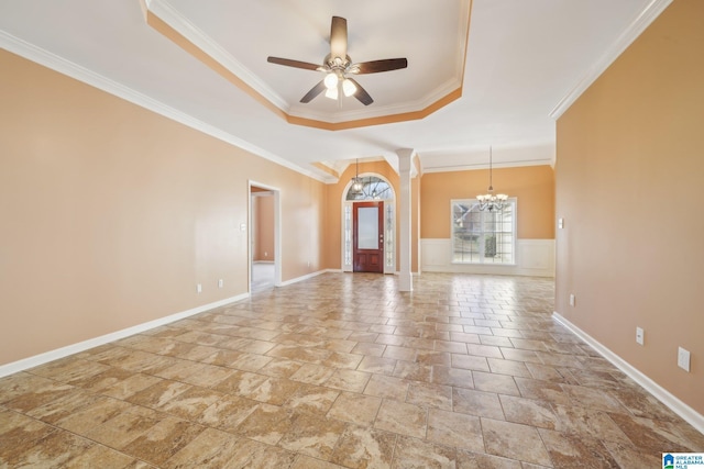 interior space with ceiling fan with notable chandelier, crown molding, and a tray ceiling