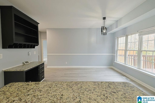 unfurnished dining area featuring light wood-type flooring