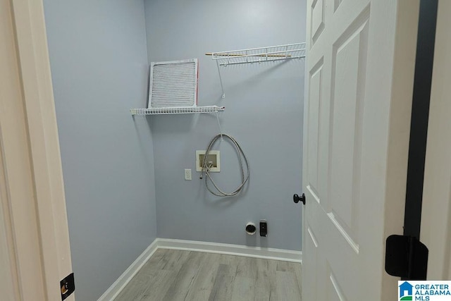 laundry area with hookup for a washing machine and light wood-type flooring