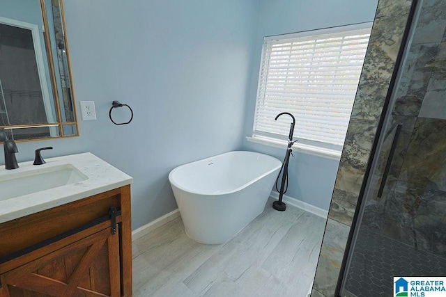 bathroom with vanity, shower with separate bathtub, and a wealth of natural light