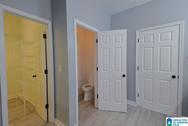 interior space featuring toilet and hardwood / wood-style floors