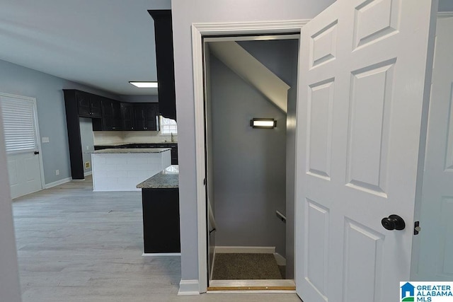 hallway with light hardwood / wood-style flooring