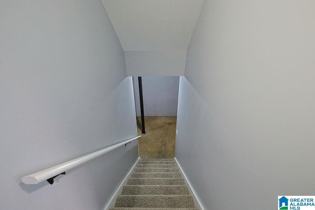 staircase featuring vaulted ceiling