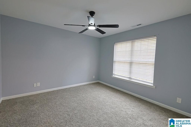 spare room with carpet floors and ceiling fan