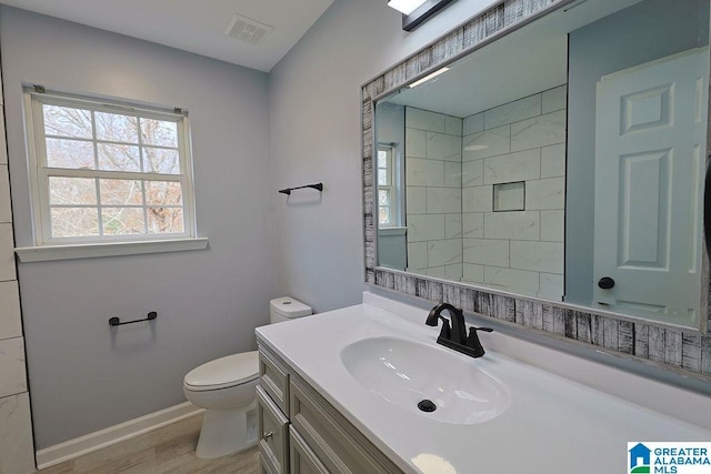 bathroom with hardwood / wood-style flooring, vanity, and toilet