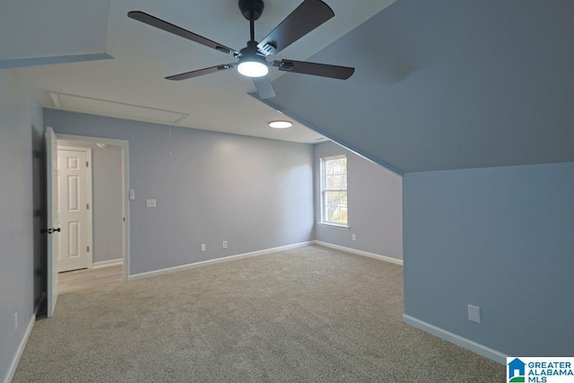 bonus room with vaulted ceiling, light colored carpet, and ceiling fan