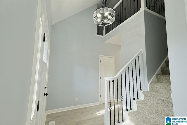 foyer featuring a high ceiling and an inviting chandelier