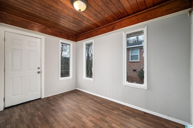 unfurnished room with baseboards, dark wood-style flooring, wooden ceiling, and a healthy amount of sunlight