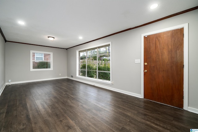 interior space featuring plenty of natural light, crown molding, baseboards, and dark wood-style flooring