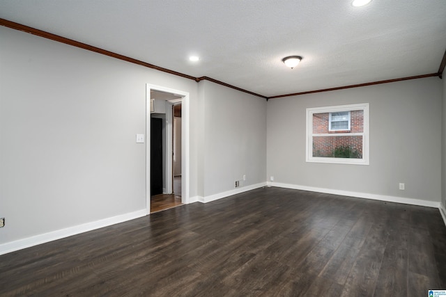 empty room with ornamental molding, dark wood-type flooring, a textured ceiling, and baseboards