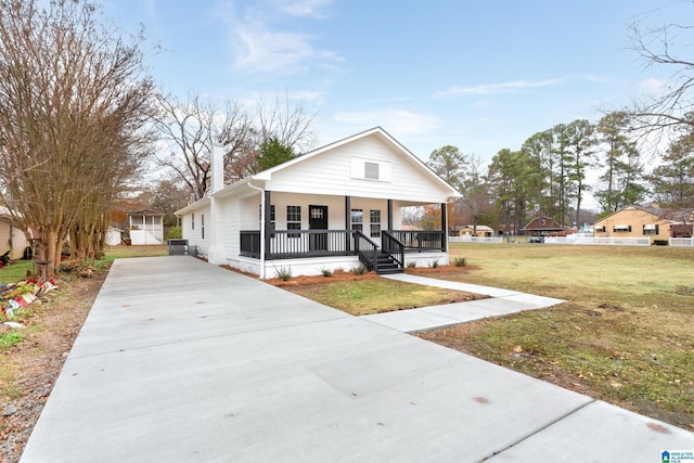 bungalow-style house featuring covered porch and a front lawn