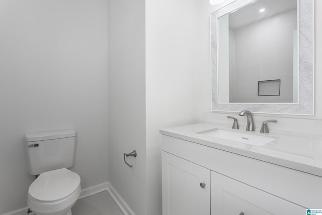 bathroom featuring tile patterned flooring, vanity, and toilet