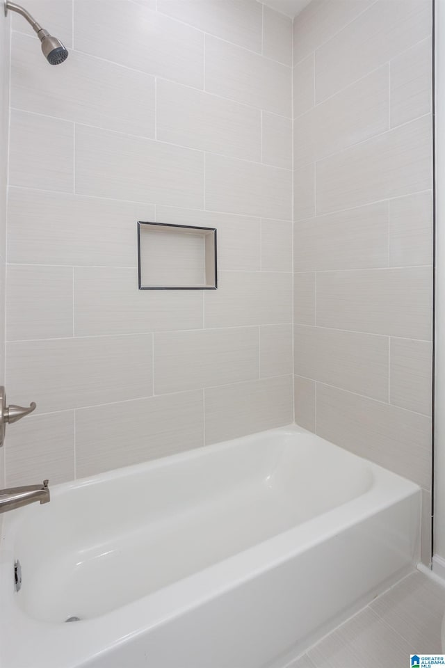 bathroom with tile patterned flooring and tiled shower / bath combo