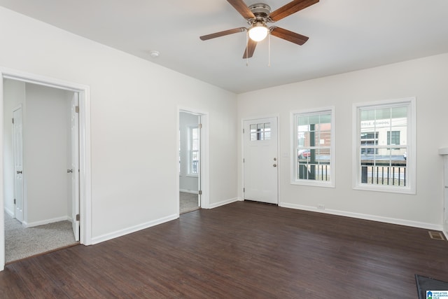 interior space with ceiling fan and dark hardwood / wood-style flooring