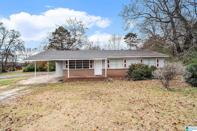 single story home featuring a front yard and a carport