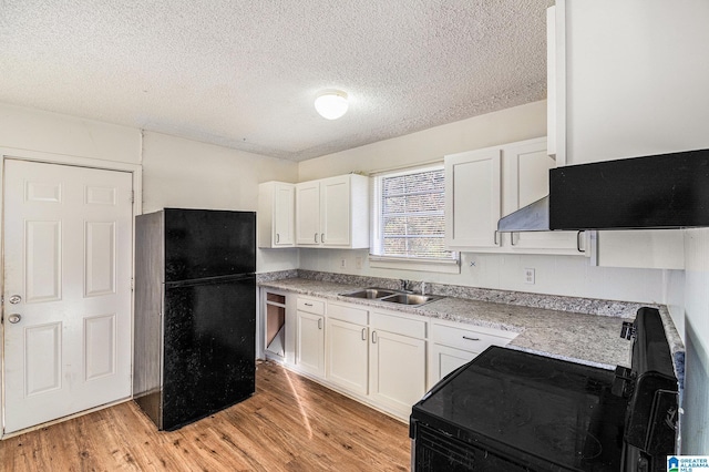 kitchen featuring black appliances, white cabinets, sink, a textured ceiling, and light hardwood / wood-style floors