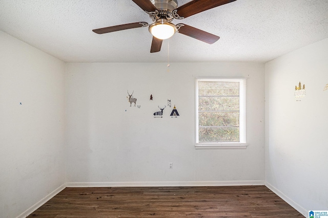 spare room with a textured ceiling, ceiling fan, and dark wood-type flooring