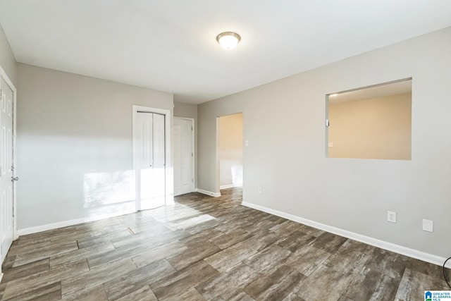 unfurnished bedroom with hardwood / wood-style floors and a closet