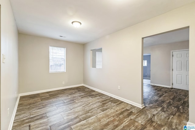 spare room with dark wood-type flooring