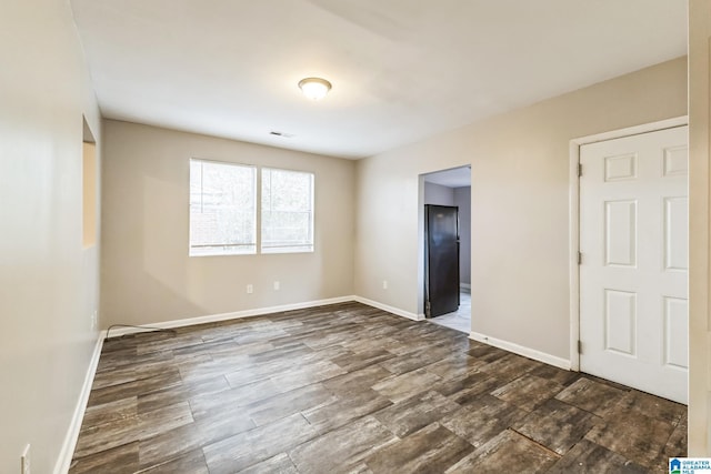 unfurnished bedroom featuring dark hardwood / wood-style floors