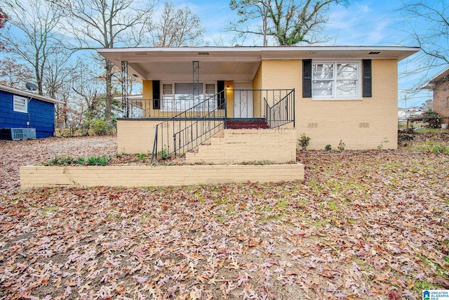 view of front of house with central AC and a porch