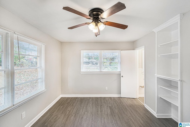 unfurnished room with ceiling fan, dark hardwood / wood-style flooring, and a healthy amount of sunlight