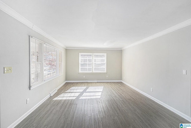 spare room featuring hardwood / wood-style flooring and ornamental molding