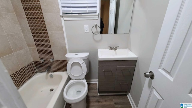 full bathroom featuring hardwood / wood-style floors, vanity, toilet, and tiled shower / bath combo