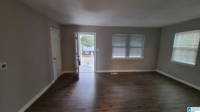 unfurnished room featuring dark hardwood / wood-style flooring