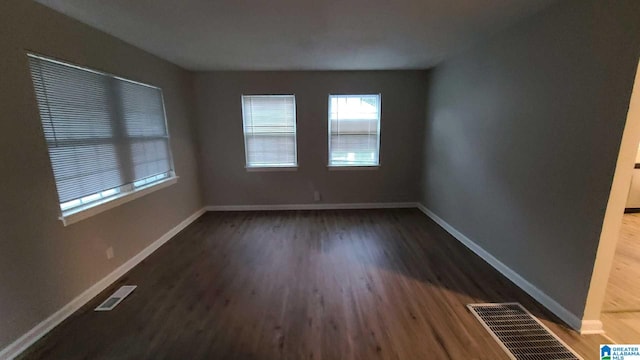 unfurnished room with dark hardwood / wood-style floors