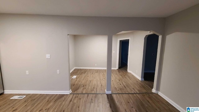 spare room with wood-type flooring