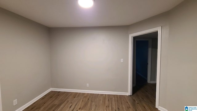 unfurnished room featuring dark hardwood / wood-style flooring