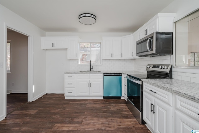 kitchen featuring white cabinets, sink, appliances with stainless steel finishes, and dark wood-type flooring