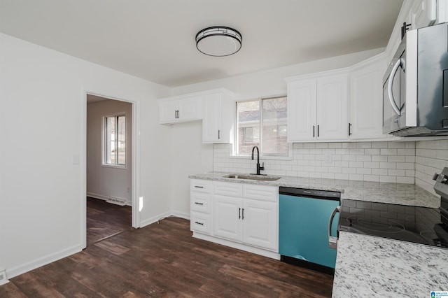 kitchen featuring plenty of natural light, sink, dark hardwood / wood-style floors, and appliances with stainless steel finishes