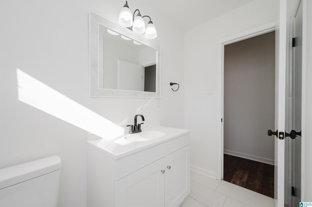 bathroom featuring tile patterned floors, vanity, and toilet