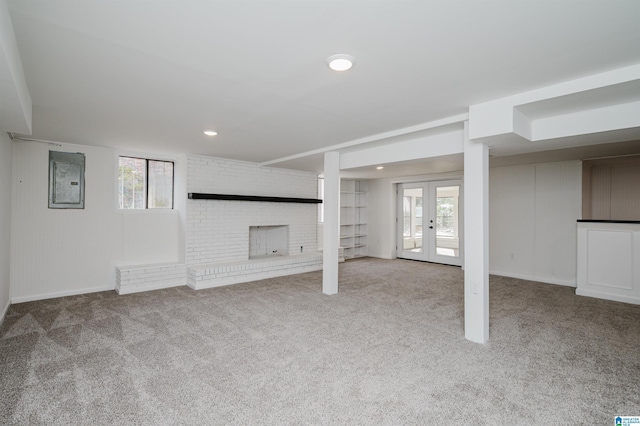 basement with a wealth of natural light, light carpet, and french doors