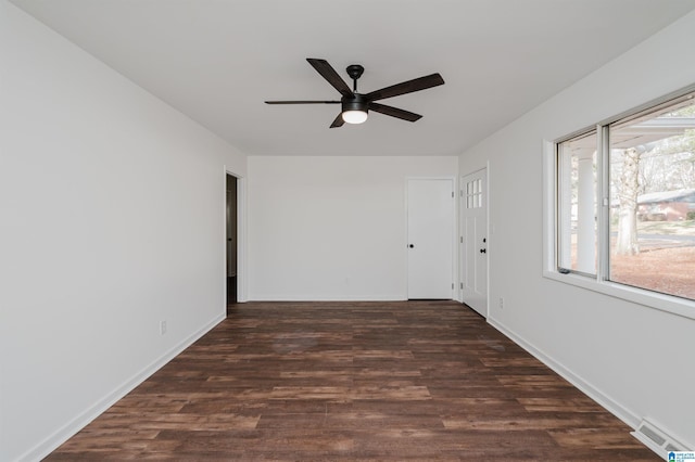 unfurnished room with ceiling fan and dark wood-type flooring