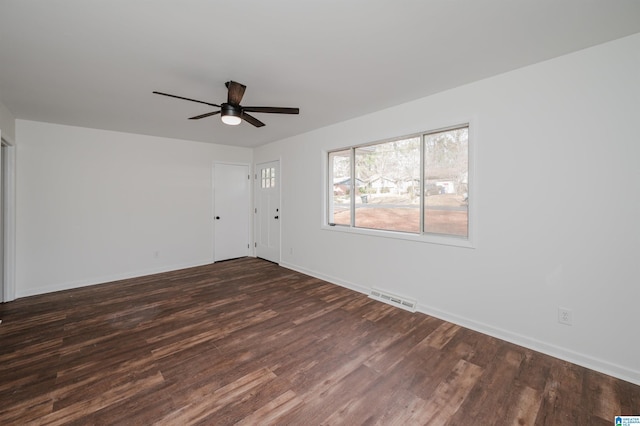 spare room with dark hardwood / wood-style flooring and ceiling fan