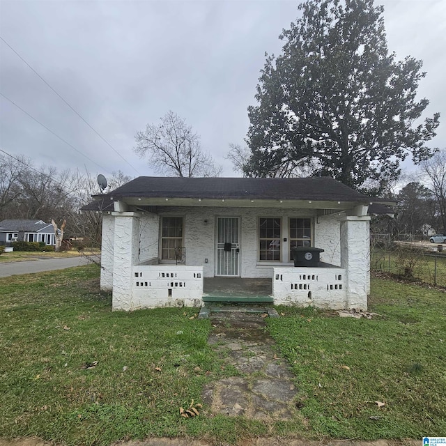 view of front of house with a porch and a front lawn